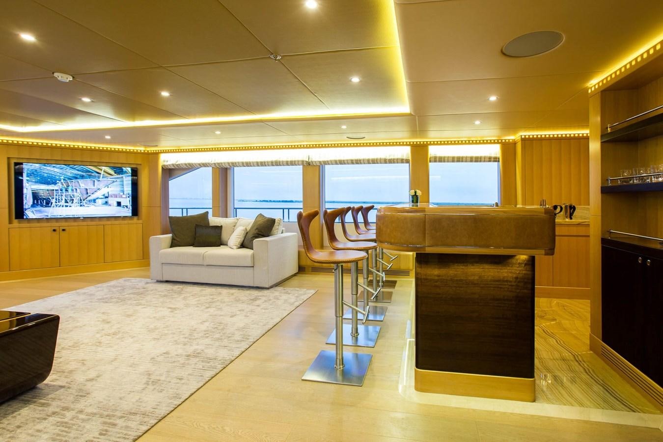 a living room with a large window aboard MAJESTY 155 Yacht for Sale