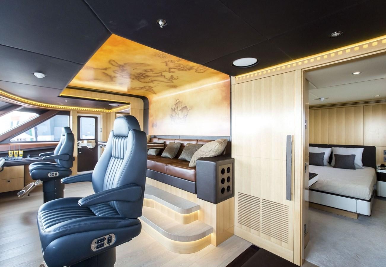 a room with a couch and a chair aboard MAJESTY 155 Yacht for Sale