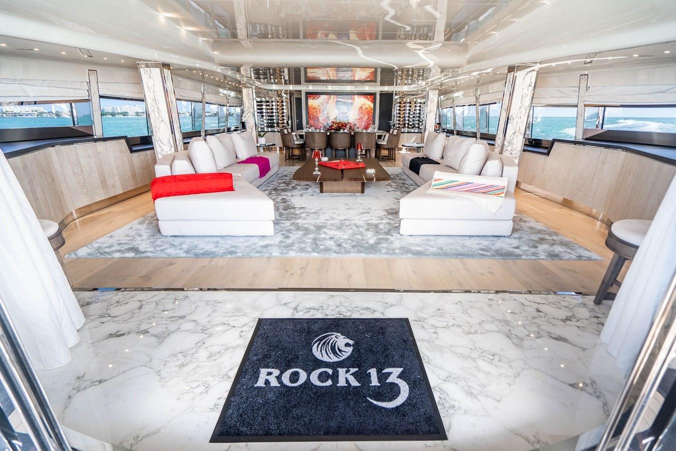 a large living room with a large glass window aboard AQUILA Yacht for Sale