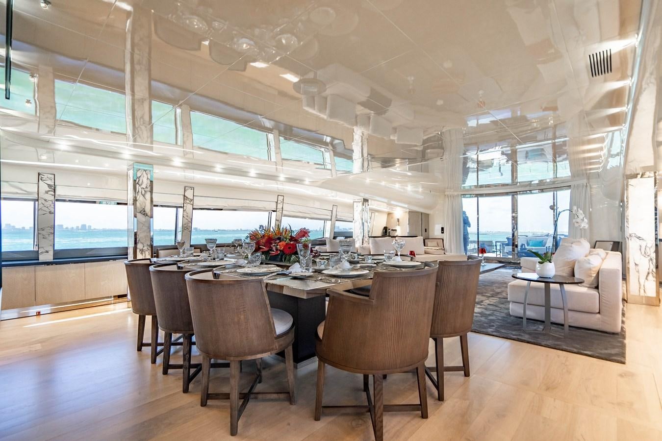 a large room with a table and chairs aboard AQUILA Yacht for Sale