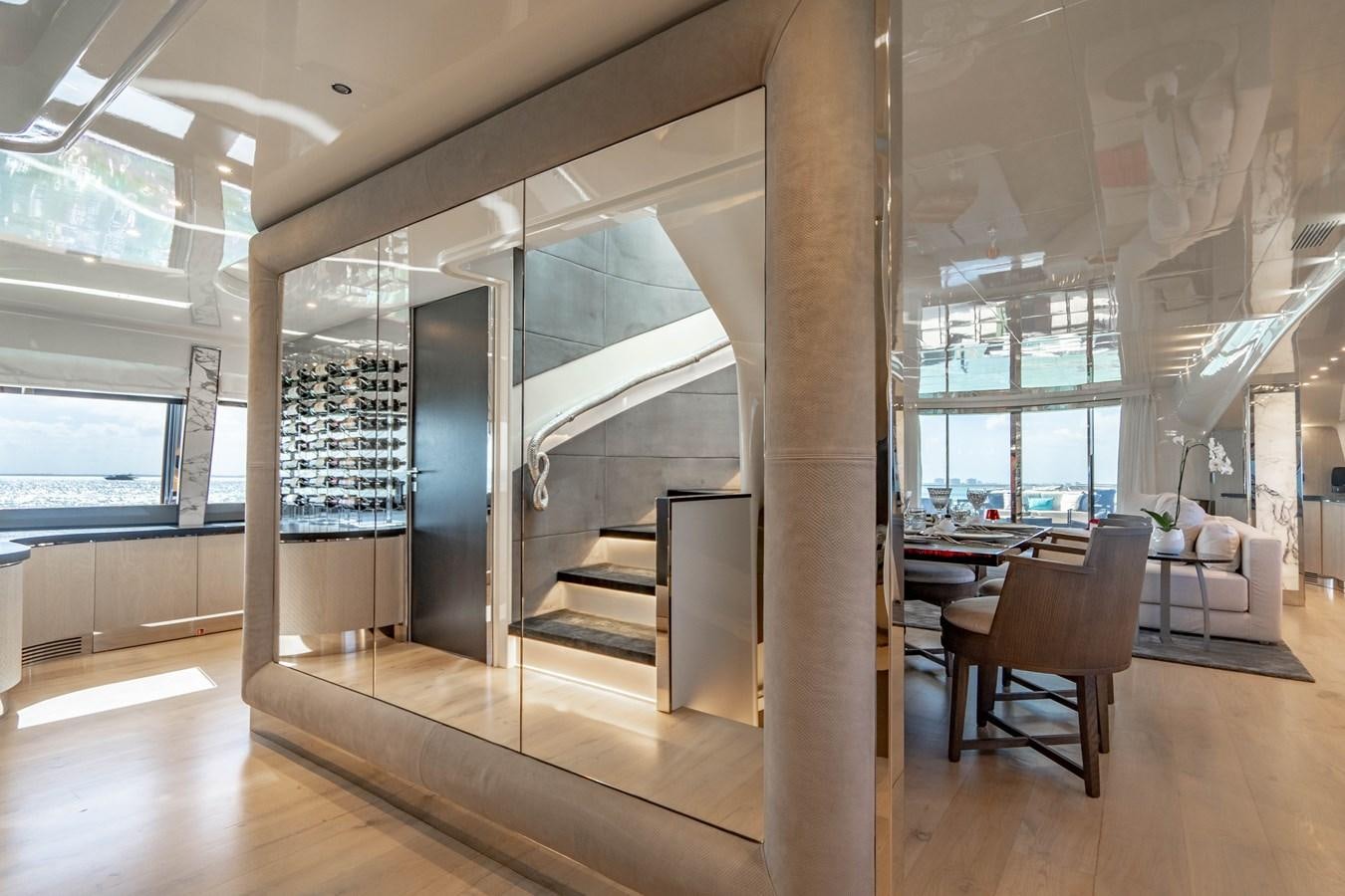 a room with a staircase and chairs aboard AQUILA Yacht for Sale