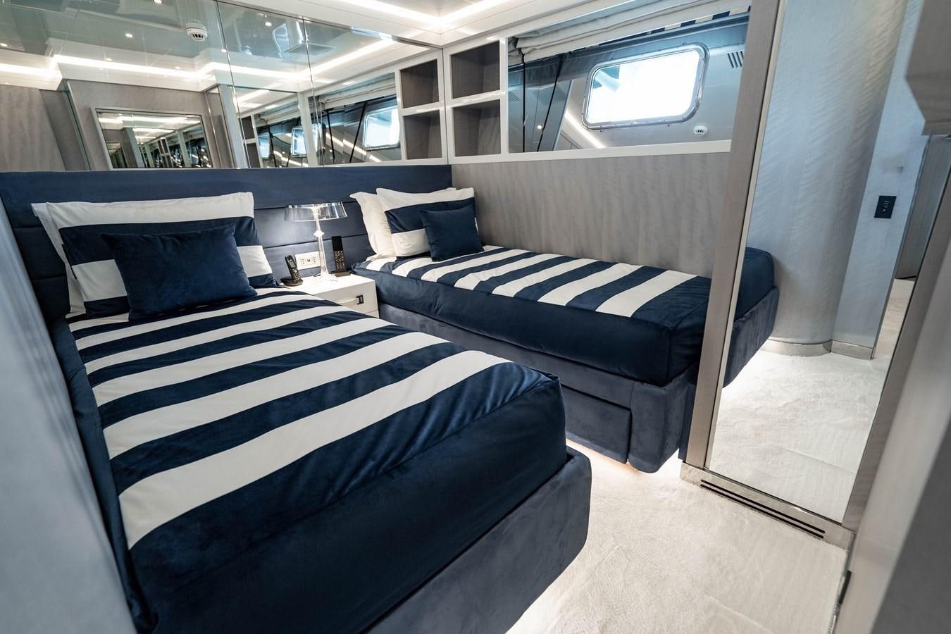a room with a bed and a window aboard AQUILA Yacht for Sale