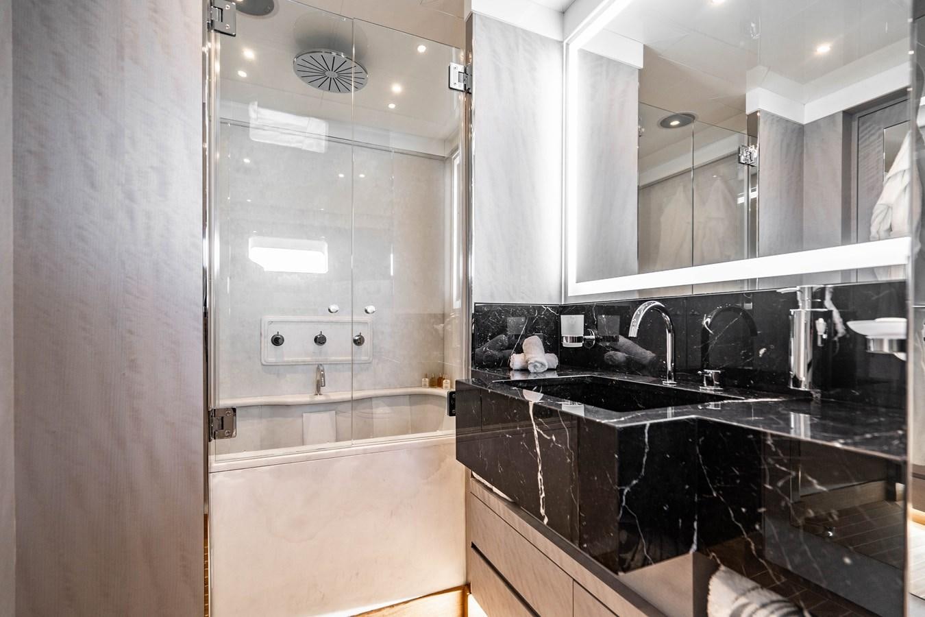 a bathroom with a glass shower aboard AQUILA Yacht for Sale