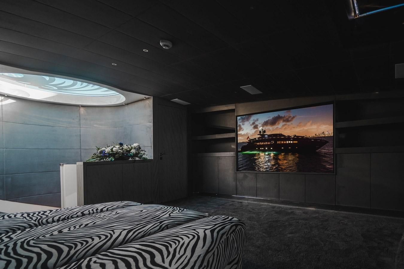 a room with a bed and a tv on the wall aboard AQUILA Yacht for Sale
