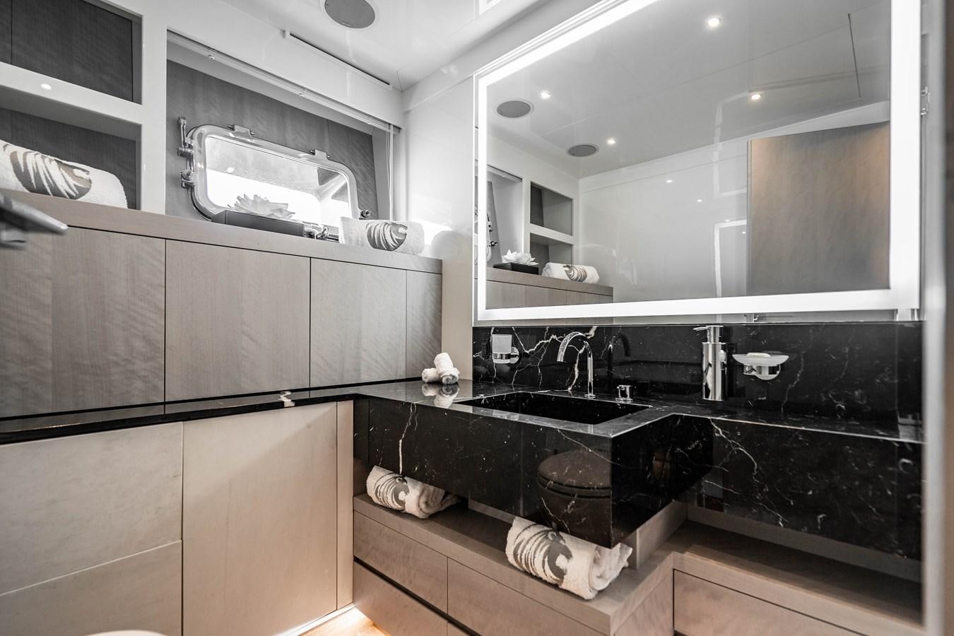 a kitchen with a sink and a mirror aboard AQUILA Yacht for Sale