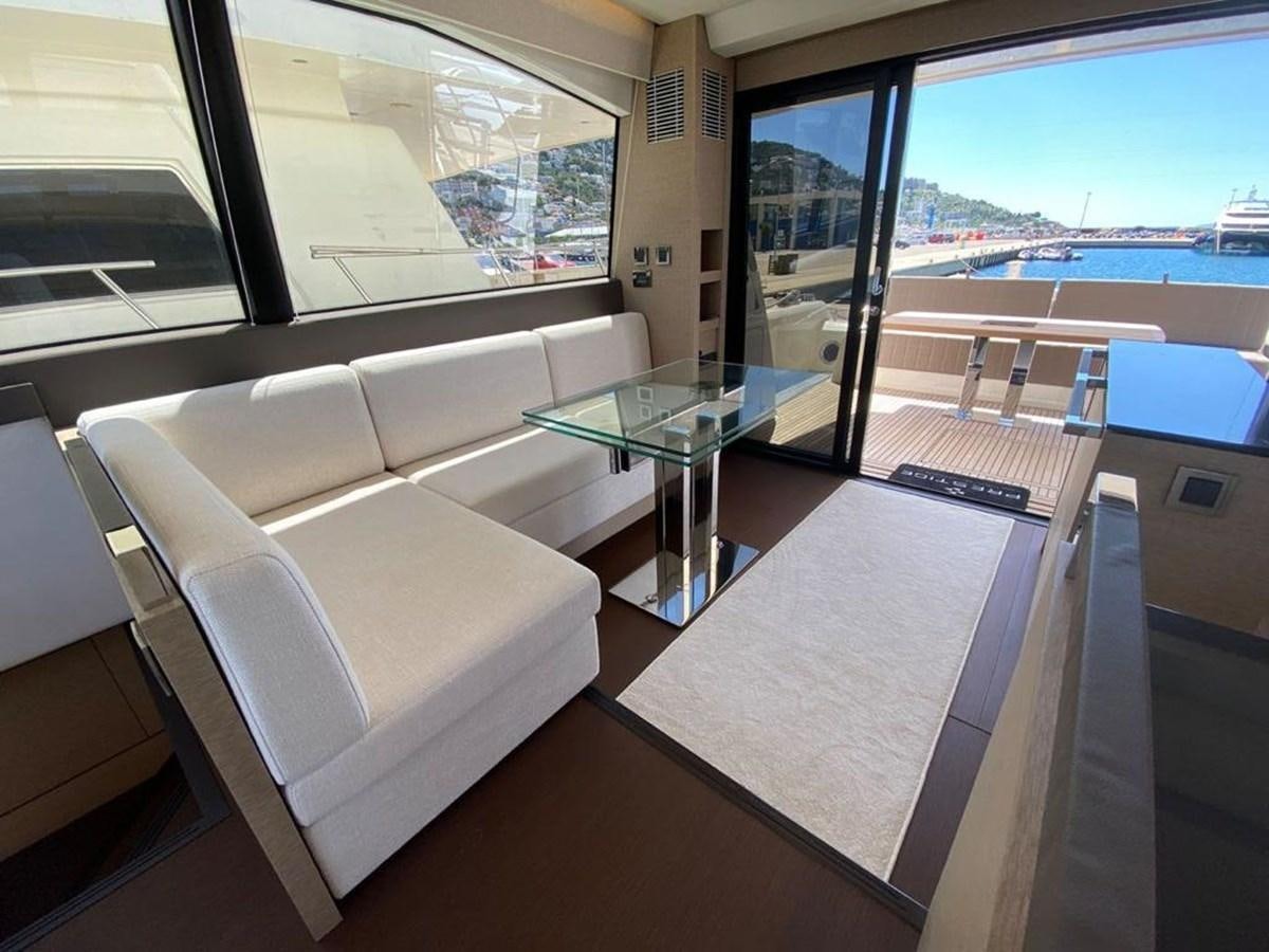 a room with a table and chairs aboard MEIGA Yacht for Sale