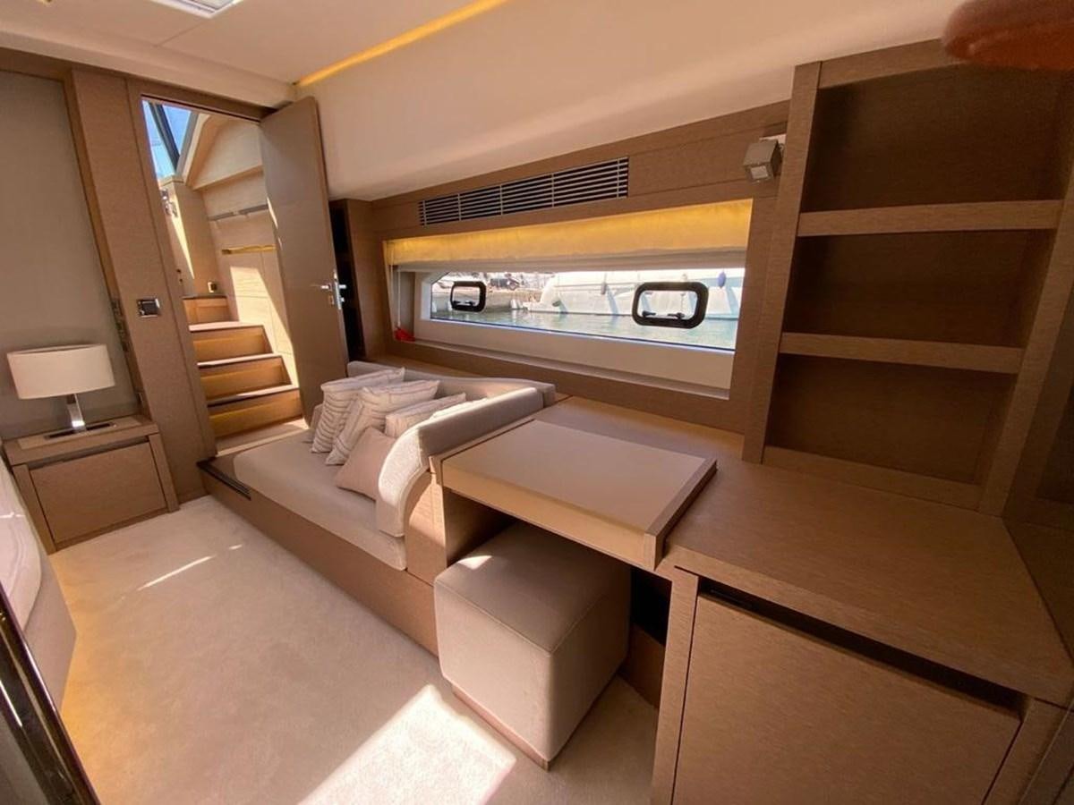 a room with a bed and a table aboard MEIGA Yacht for Sale