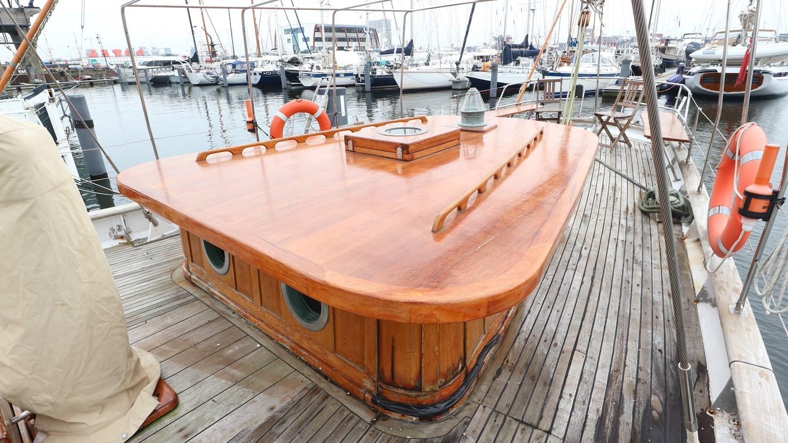 a wooden boat on a dock aboard ARIES Yacht for Sale