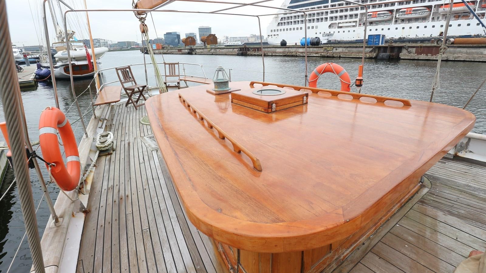 a wooden boat on a dock aboard ARIES Yacht for Sale