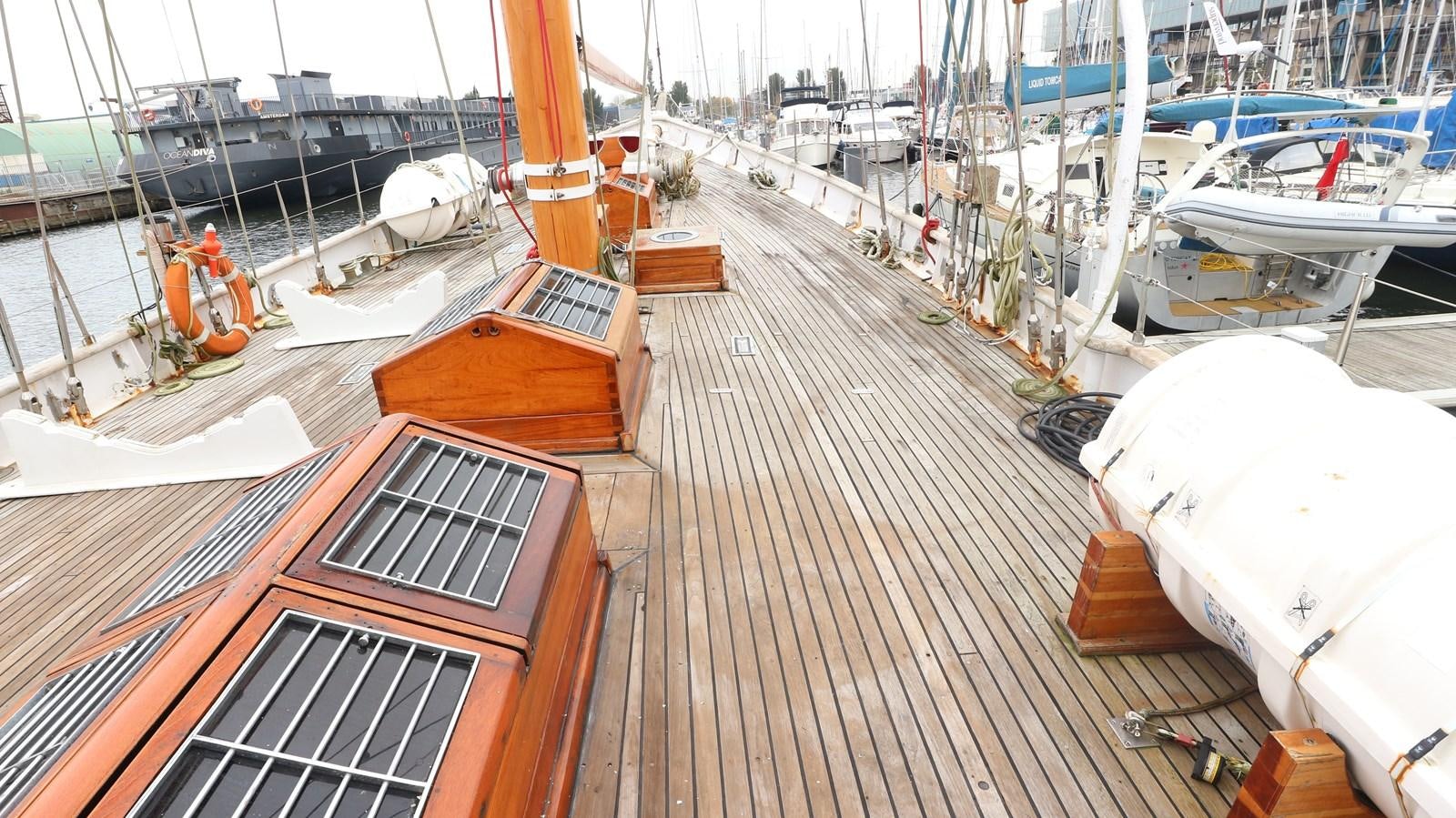 a wooden deck with many boats aboard ARIES Yacht for Sale