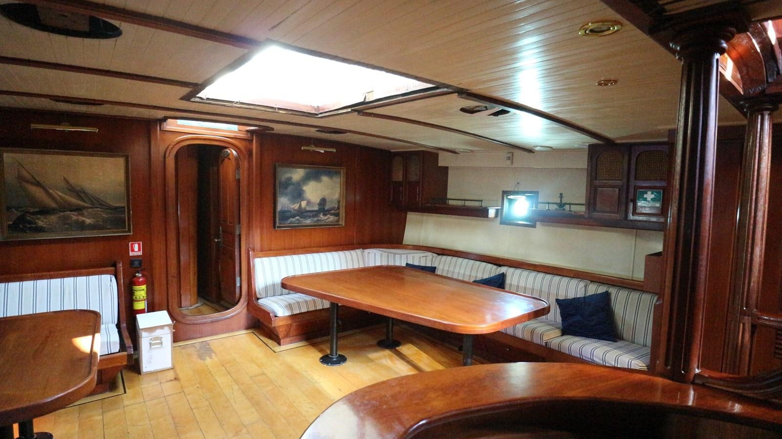 a room with a bed and a table aboard ARIES Yacht for Sale