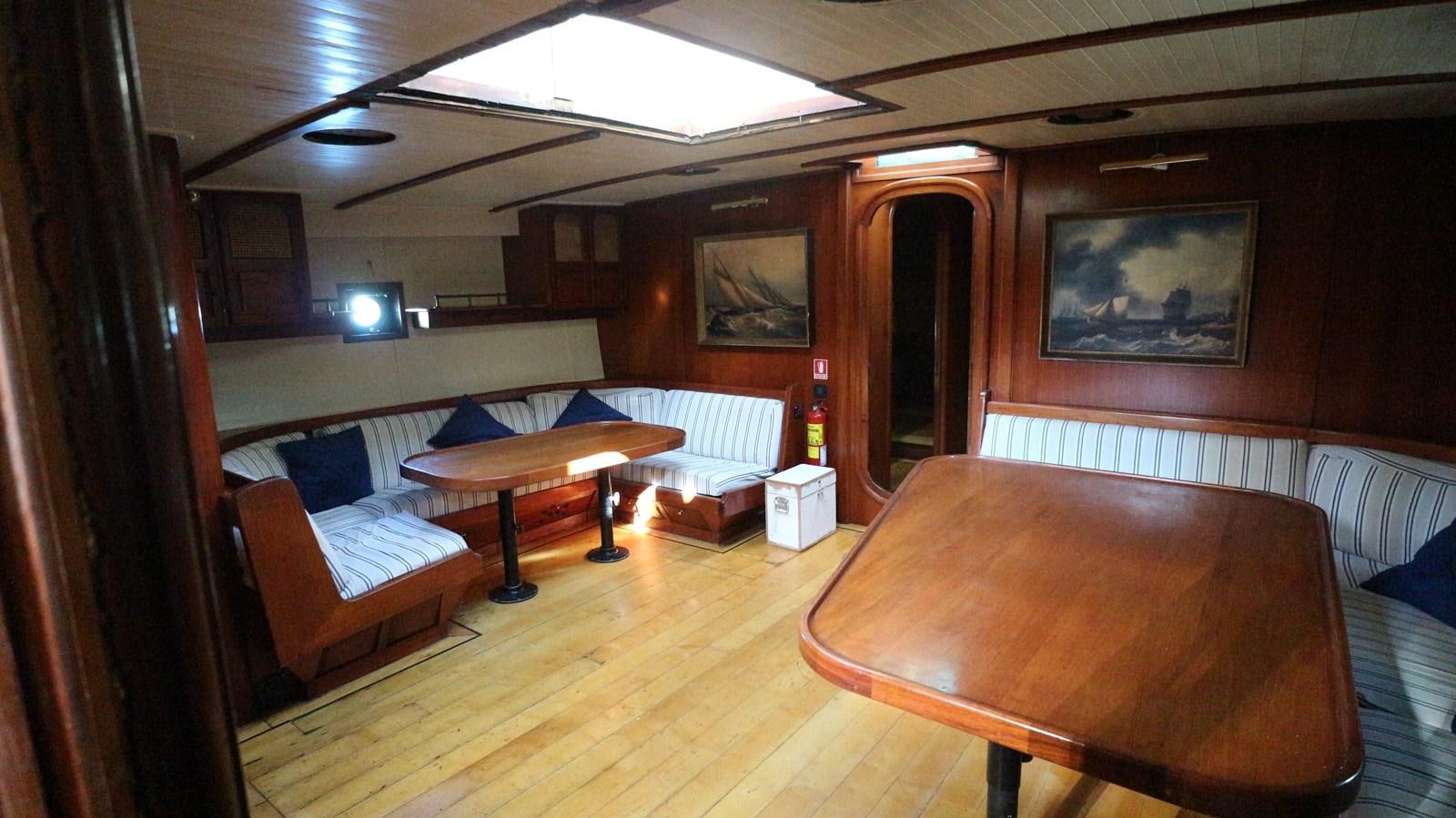 a room with a table and chairs aboard ARIES Yacht for Sale
