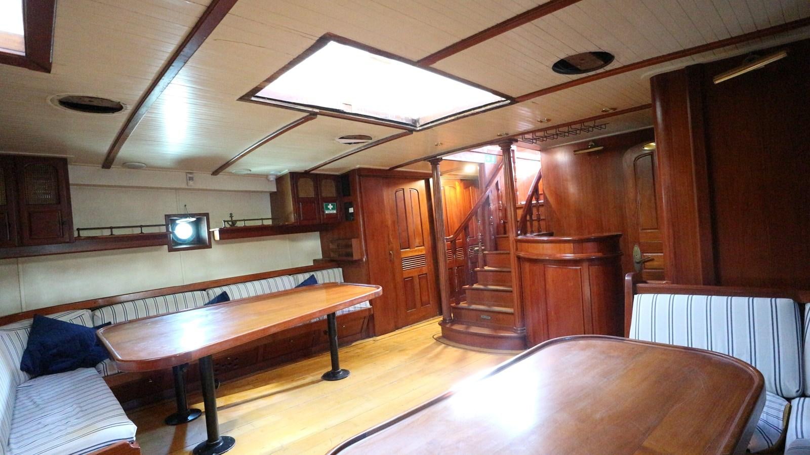 a room with a pool table and chairs aboard ARIES Yacht for Sale