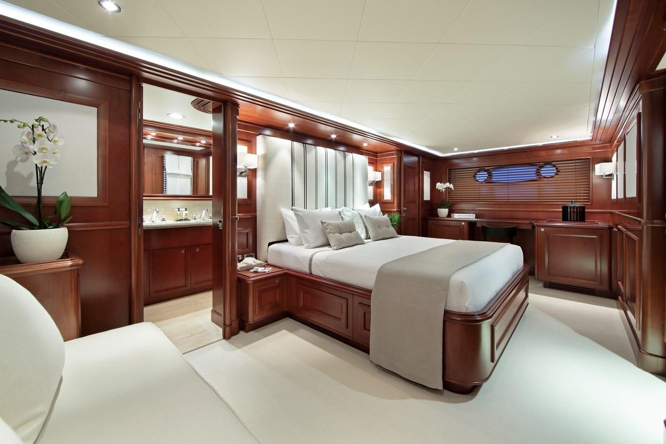 a bedroom with a bed and a desk aboard LADY SOUL Yacht for Sale