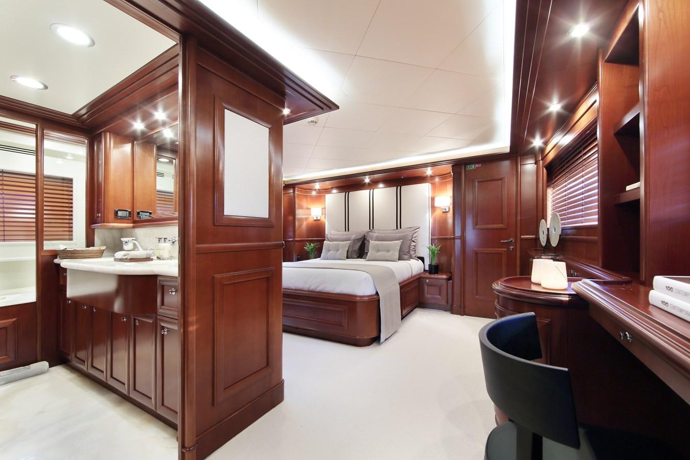 a bedroom with a bed and desk aboard LADY SOUL Yacht for Sale