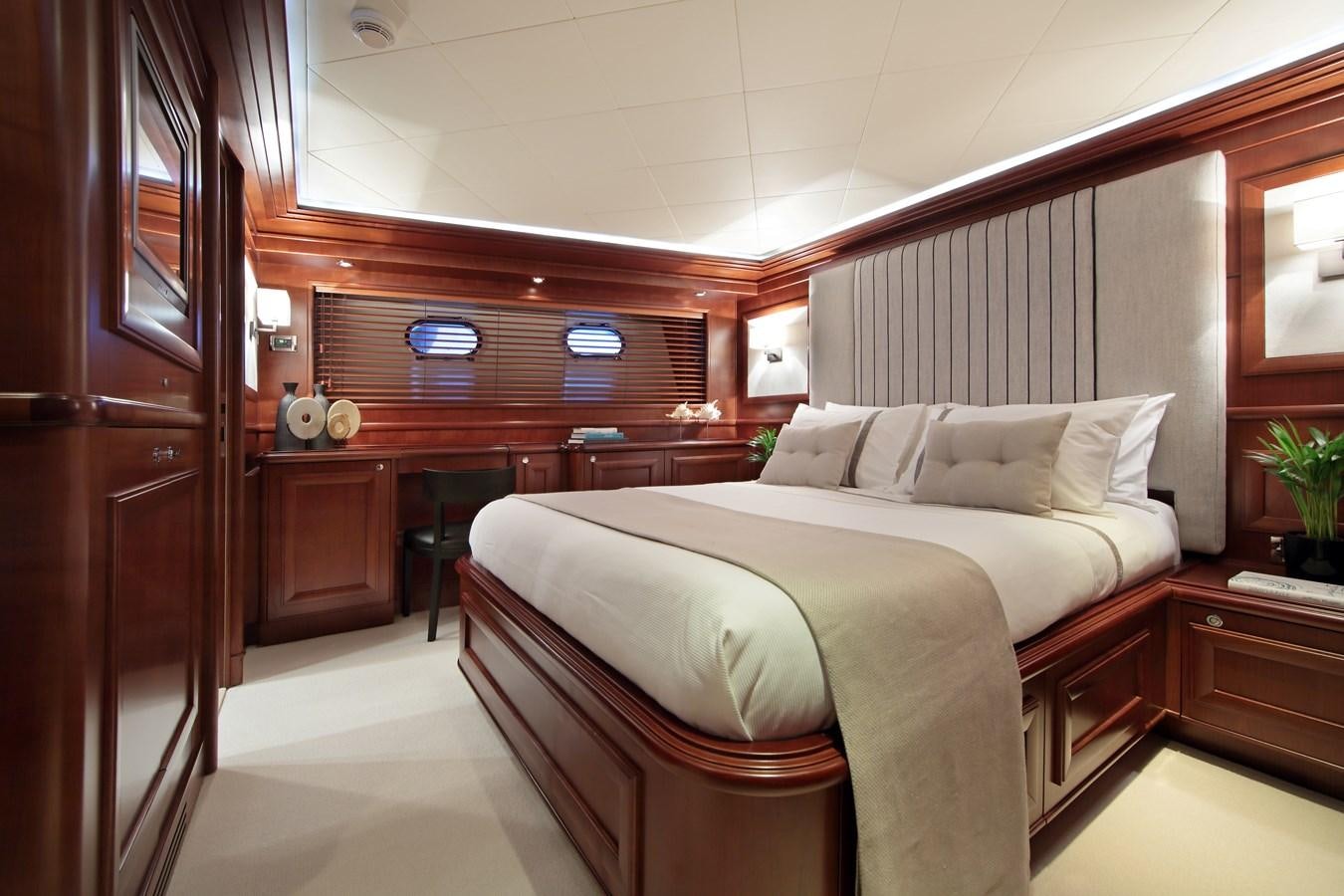 a bedroom with a bed and desk aboard LADY SOUL Yacht for Sale