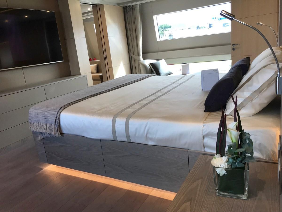 a bed with a black and white bed spread aboard ALEGRE Yacht for Sale
