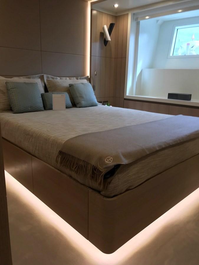 a bed with a white sheet and pillows aboard ALEGRE Yacht for Sale