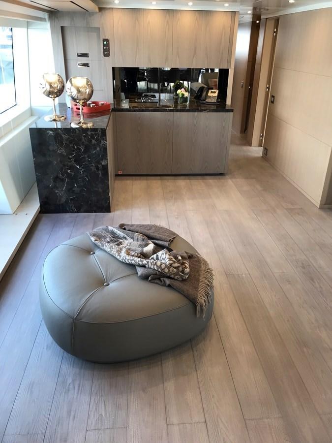 a dog lying on a rug on a wood floor in a kitchen aboard ALEGRE Yacht for Sale