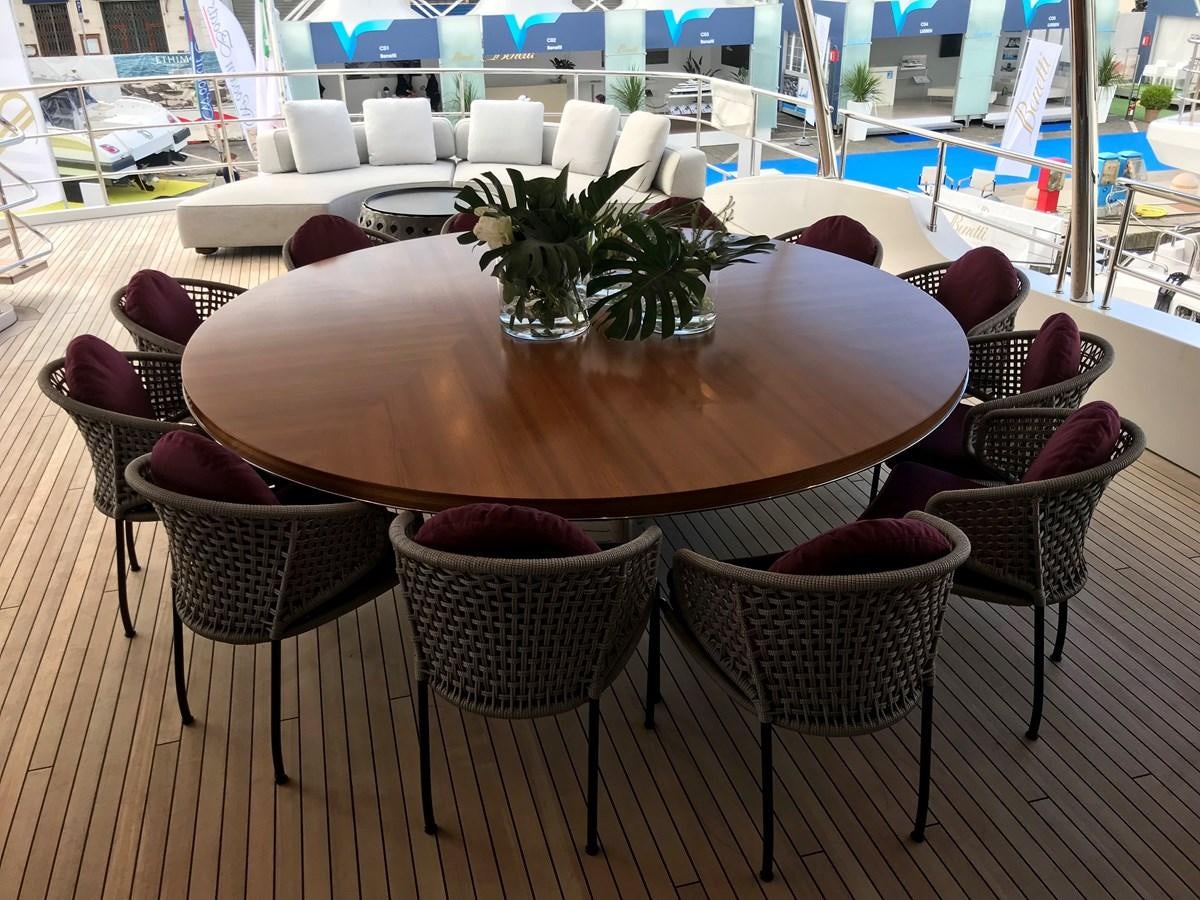 a table with chairs and a plant on it aboard ALEGRE Yacht for Sale