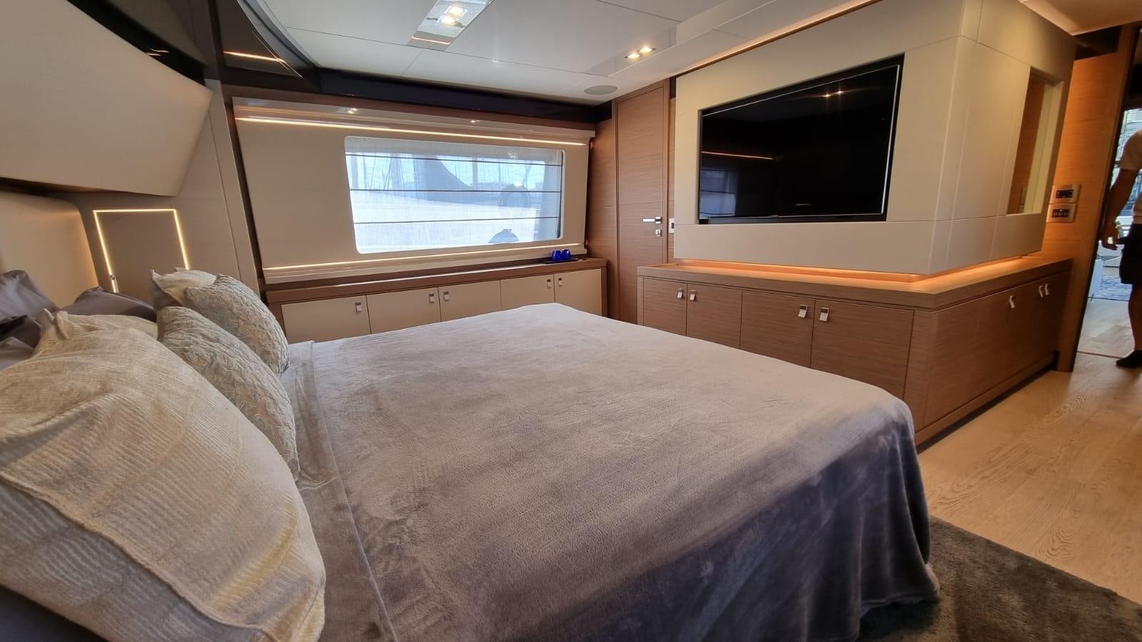 a bedroom with a bed and a tv aboard MERIDIANA Yacht for Sale
