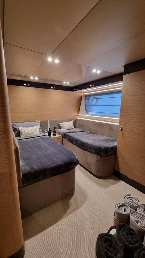 a bedroom with a bed and a window aboard MERIDIANA Yacht for Sale