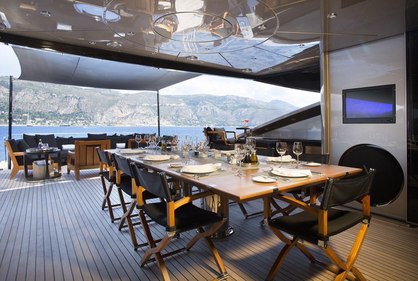 a restaurant with a table and chairs aboard DEFIANT Yacht for Sale