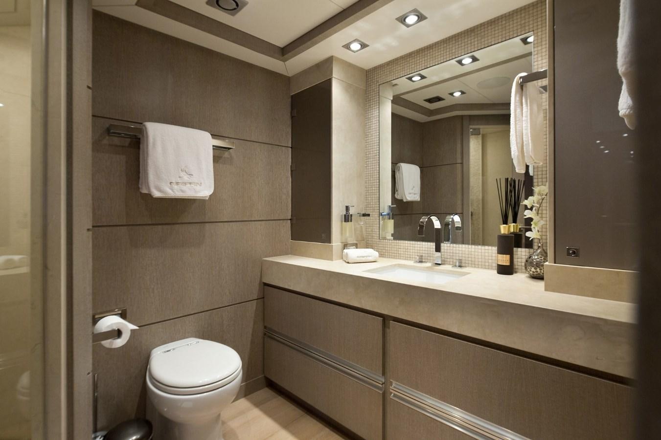 a bathroom with a toilet and a sink aboard DEFIANT Yacht for Sale