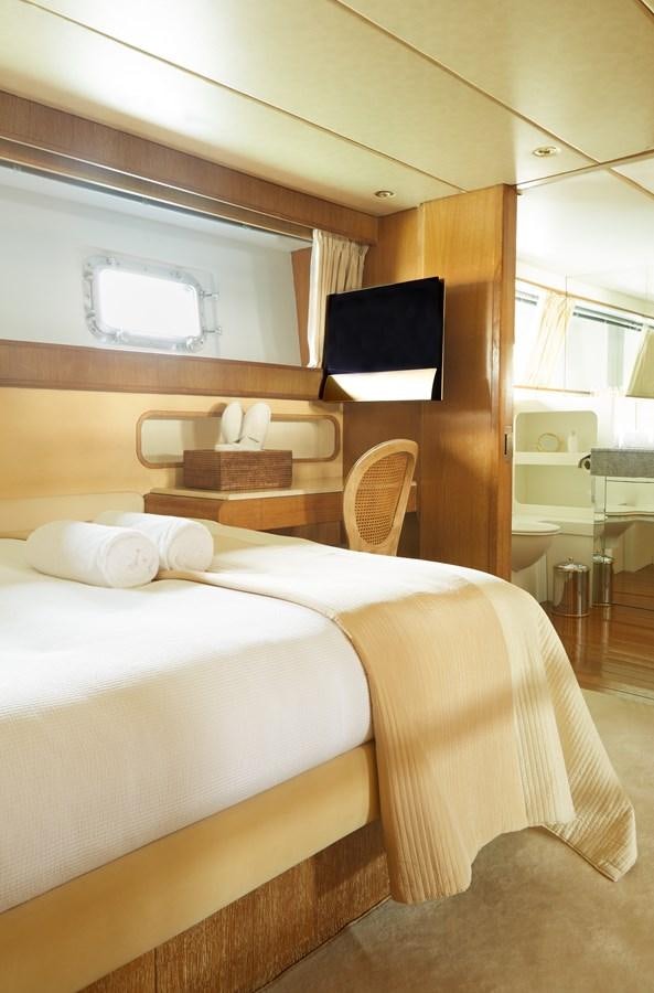 a bed with a black pillow aboard SEA LADY II Yacht for Sale