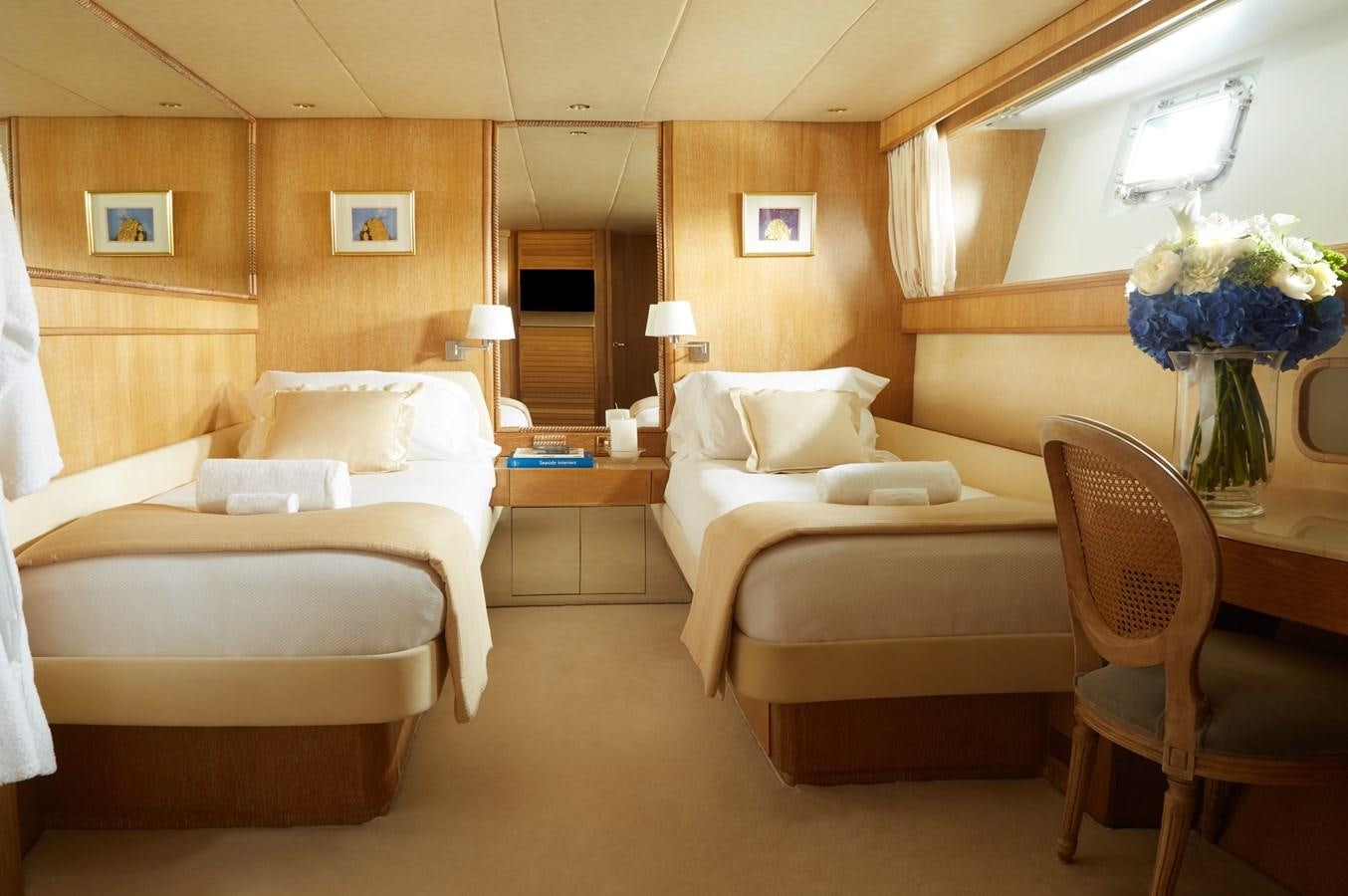 a room with a bed and a chair aboard SEA LADY II Yacht for Sale