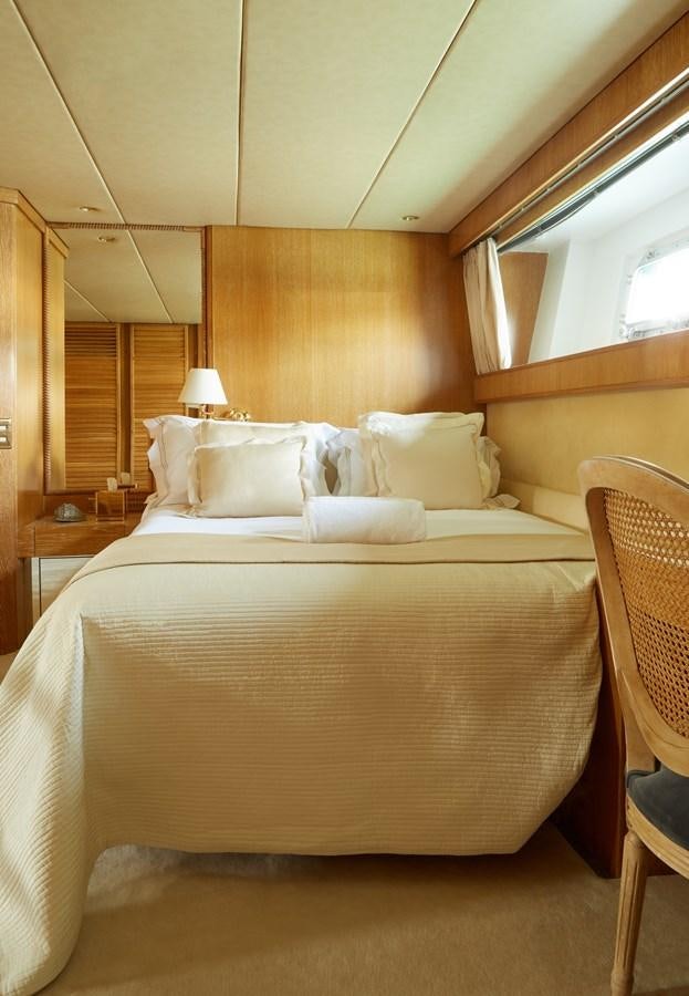 a bed with white sheets aboard SEA LADY II Yacht for Sale