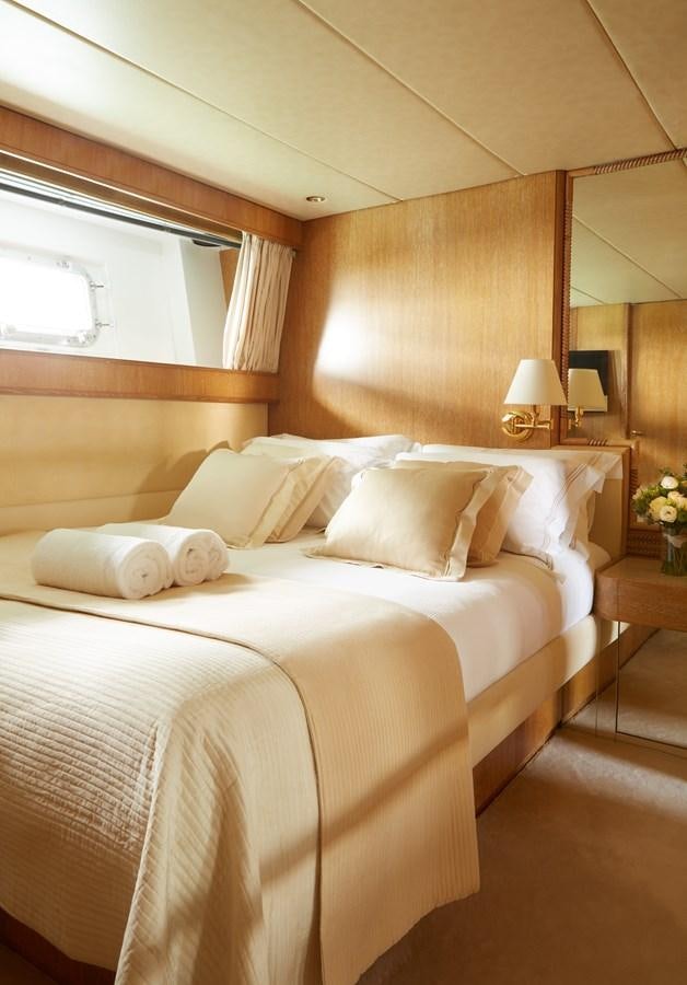 a bed with white sheets aboard SEA LADY II Yacht for Sale