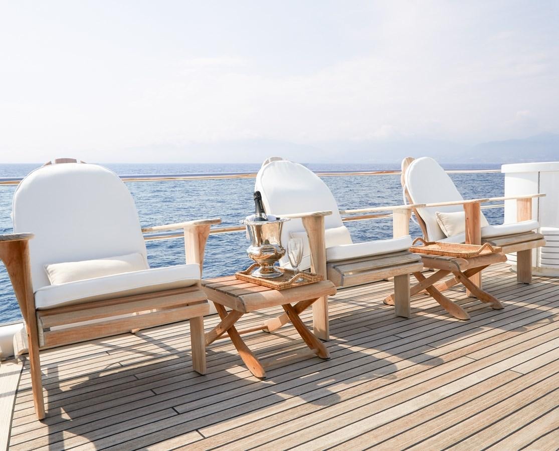 a wooden table on a deck overlooking the ocean aboard SEA LADY II Yacht for Sale
