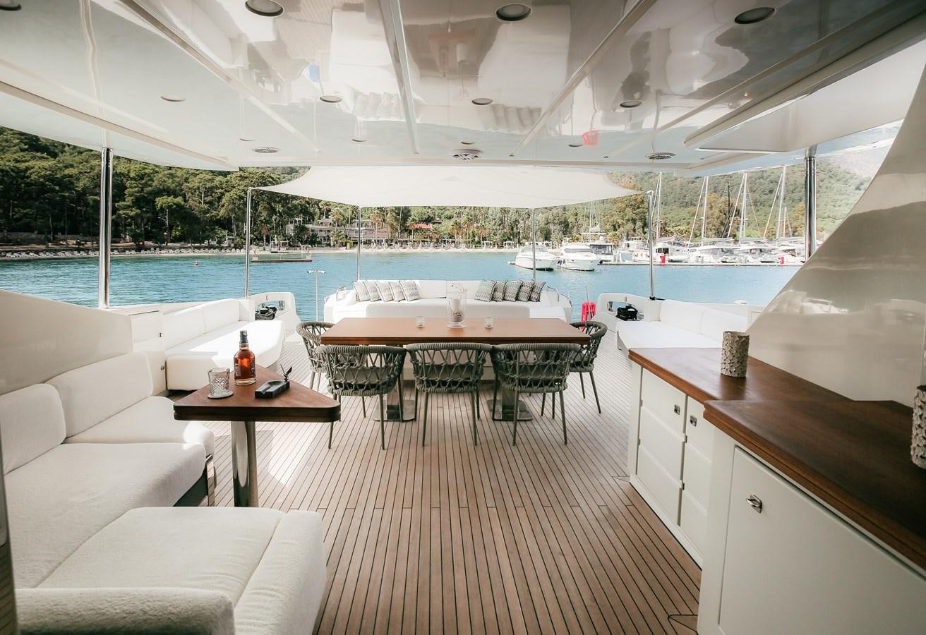 a room with a table chairs and a pool aboard PATRONESS Yacht for Sale