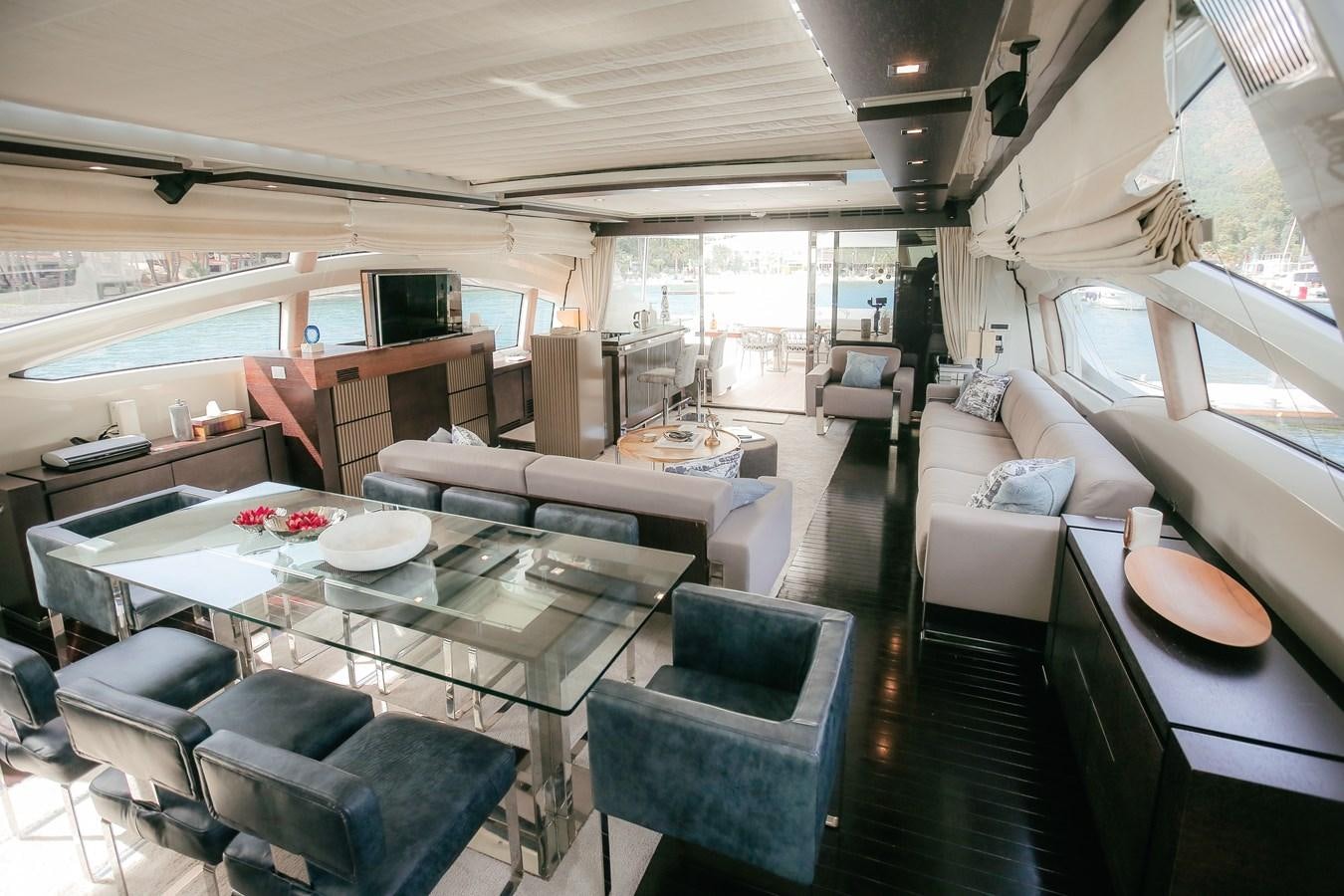 a room with a table chairs and a couch aboard PATRONESS Yacht for Sale