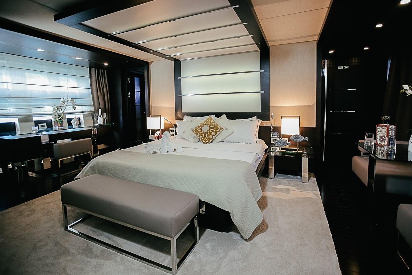 a bedroom with a bed and a desk aboard PATRONESS Yacht for Sale