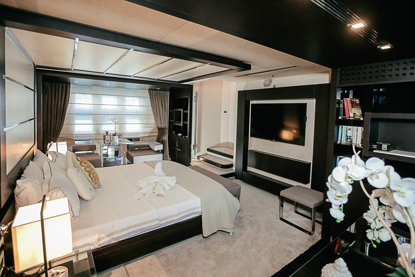a bedroom with a bed and a television aboard PATRONESS Yacht for Sale