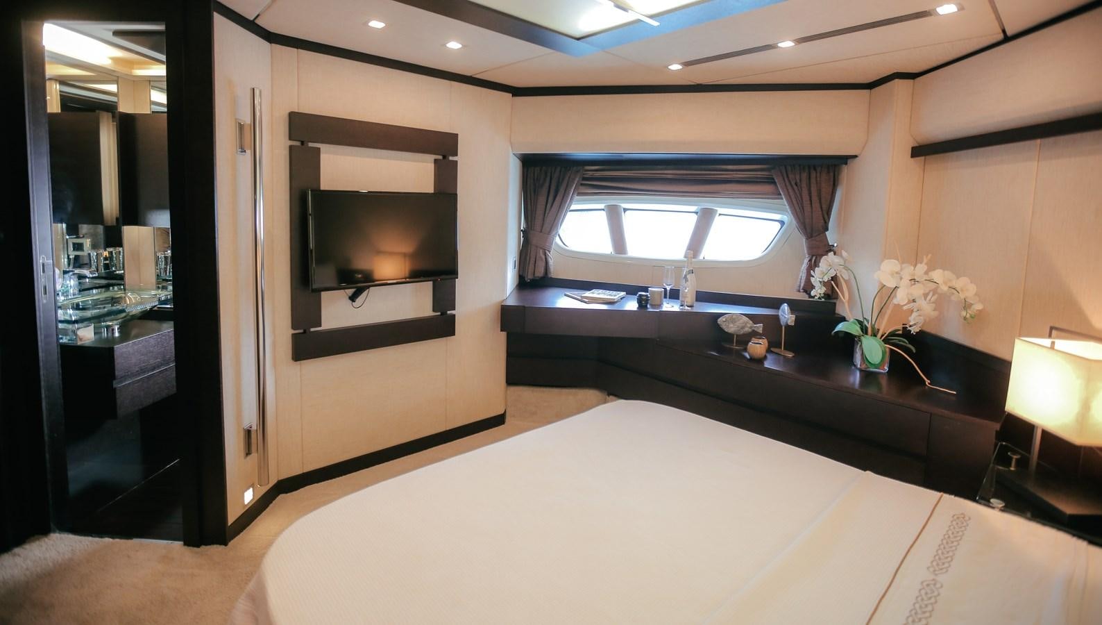 a room with a table and a tv aboard PATRONESS Yacht for Sale