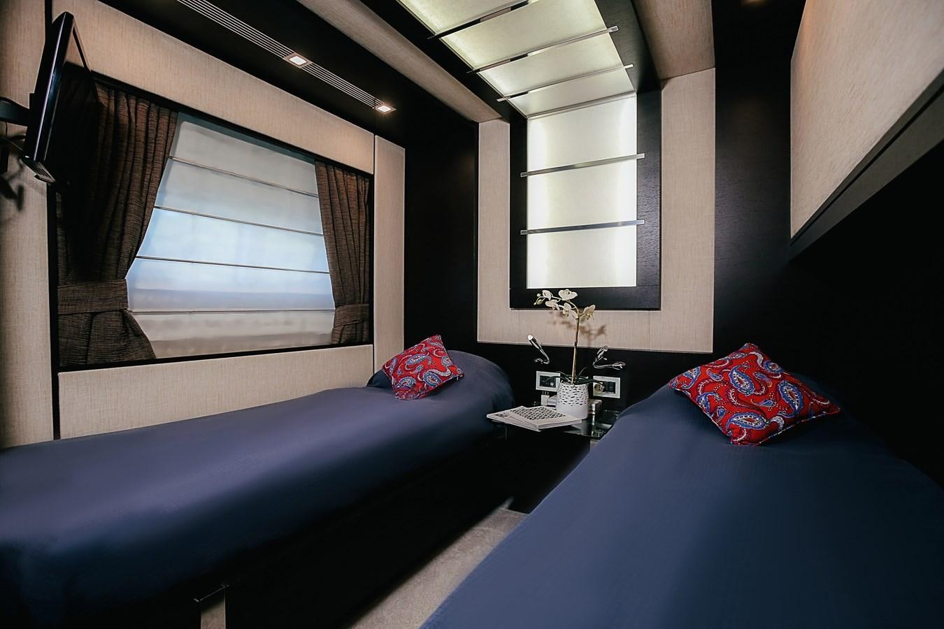 a bedroom with a bed and a window aboard PATRONESS Yacht for Sale