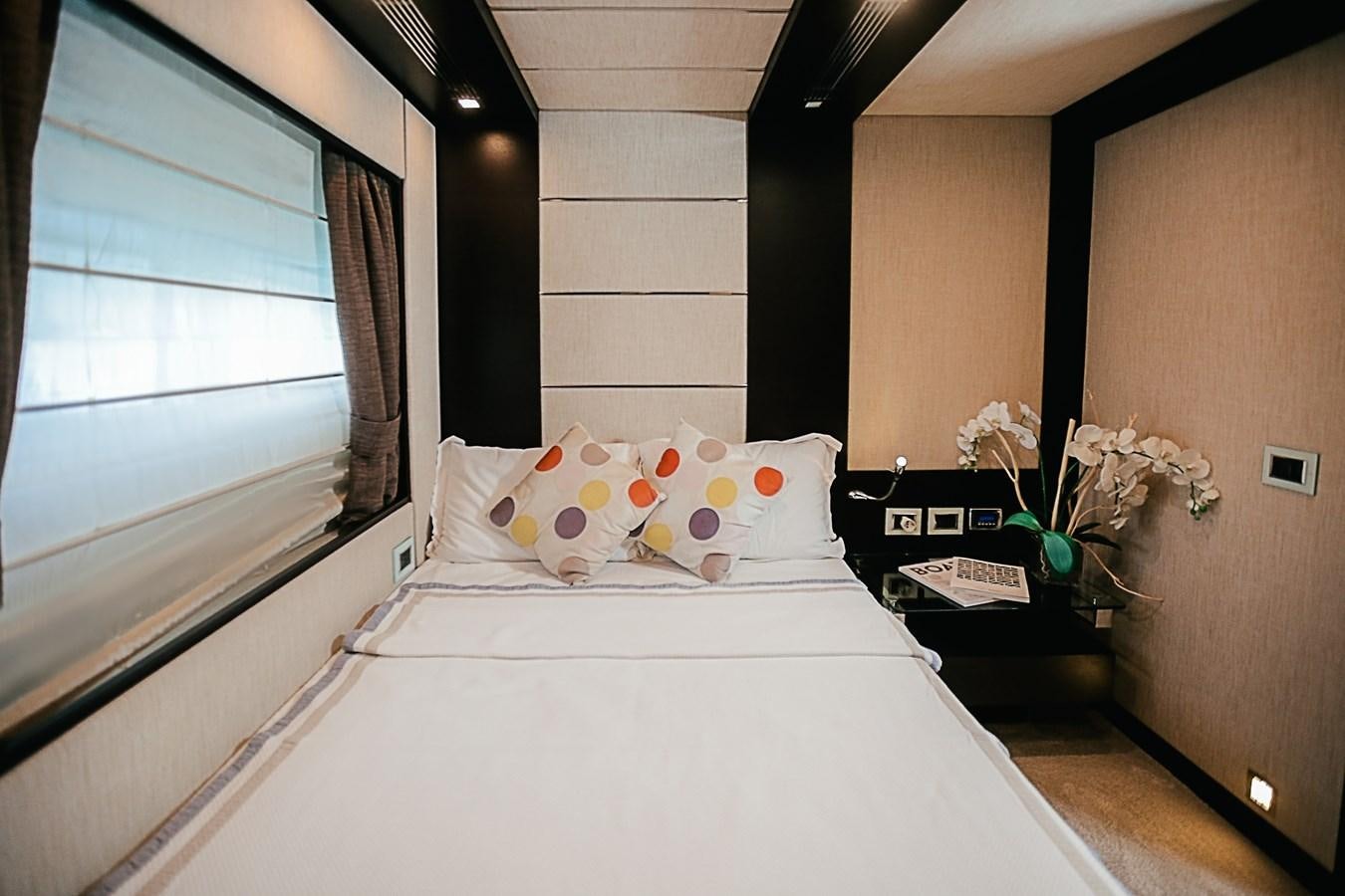 a bed with white sheets and pillows aboard PATRONESS Yacht for Sale