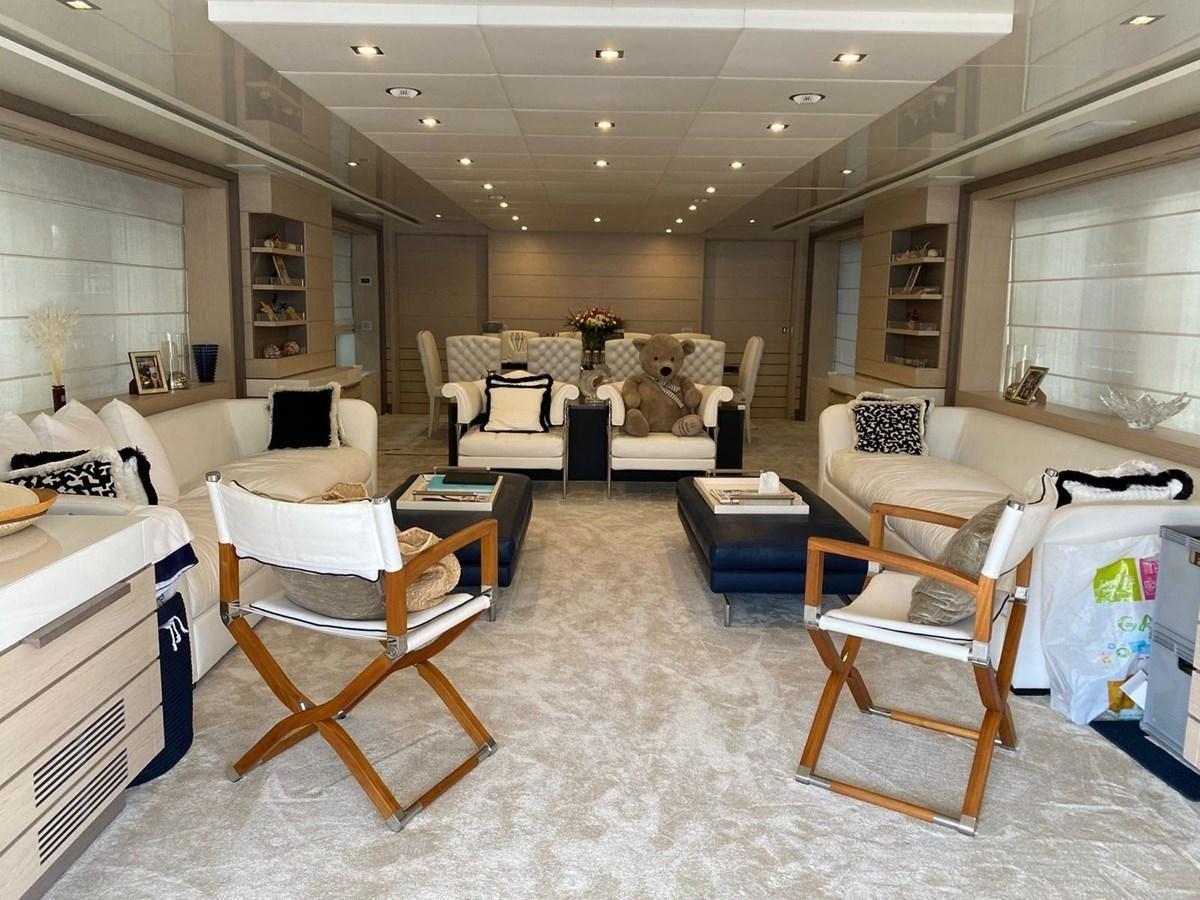 a room with a couch and chairs aboard CLASSIC 121 Yacht for Sale