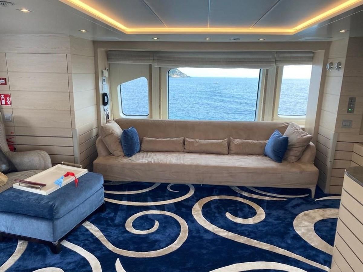 a living room with a couch and a rug aboard CLASSIC 121 Yacht for Sale