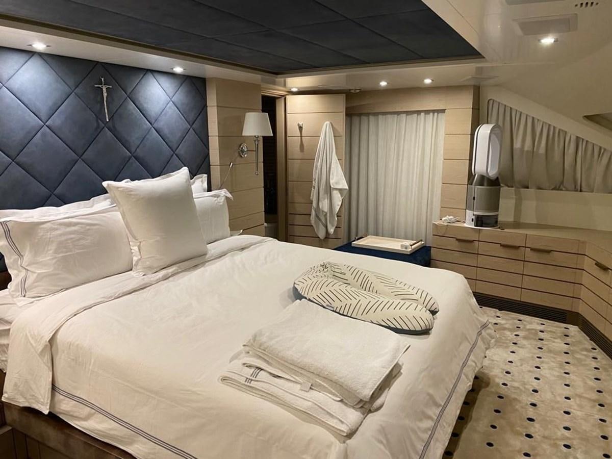 a bed with white sheets aboard CLASSIC 121 Yacht for Sale
