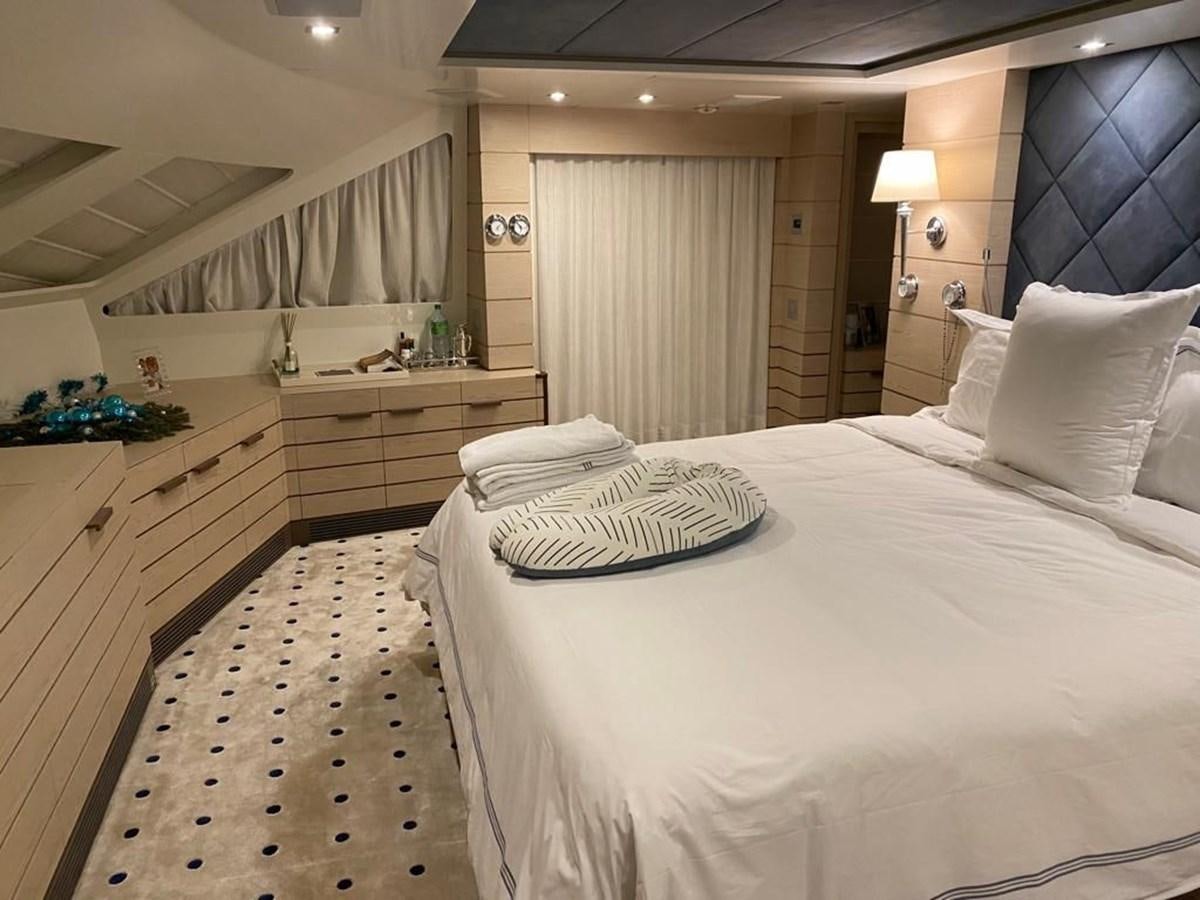 a bedroom with a bed and a desk aboard CLASSIC 121 Yacht for Sale