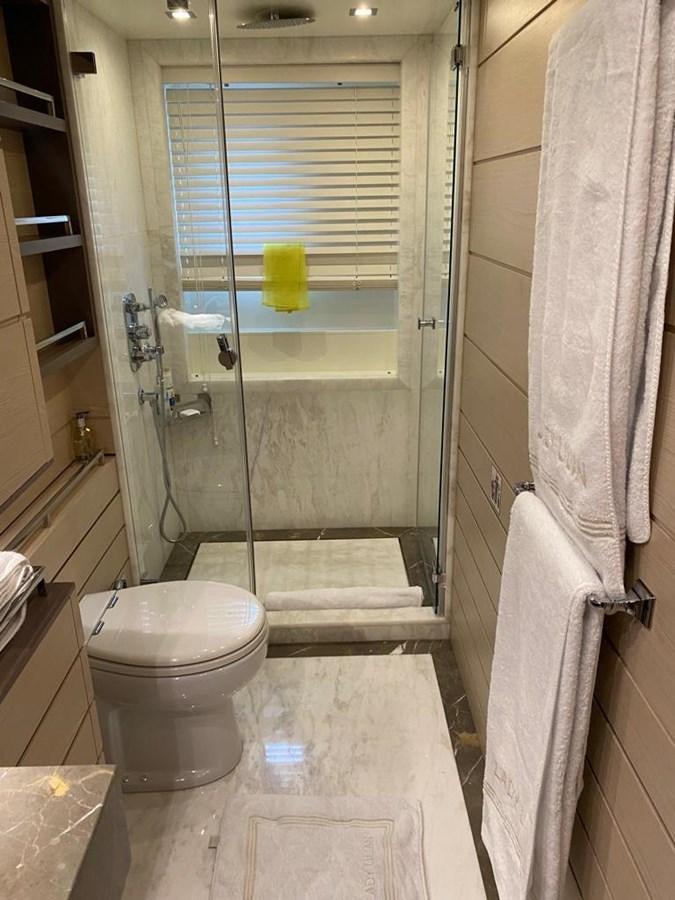 a bathroom with a glass shower door aboard CLASSIC 121 Yacht for Sale