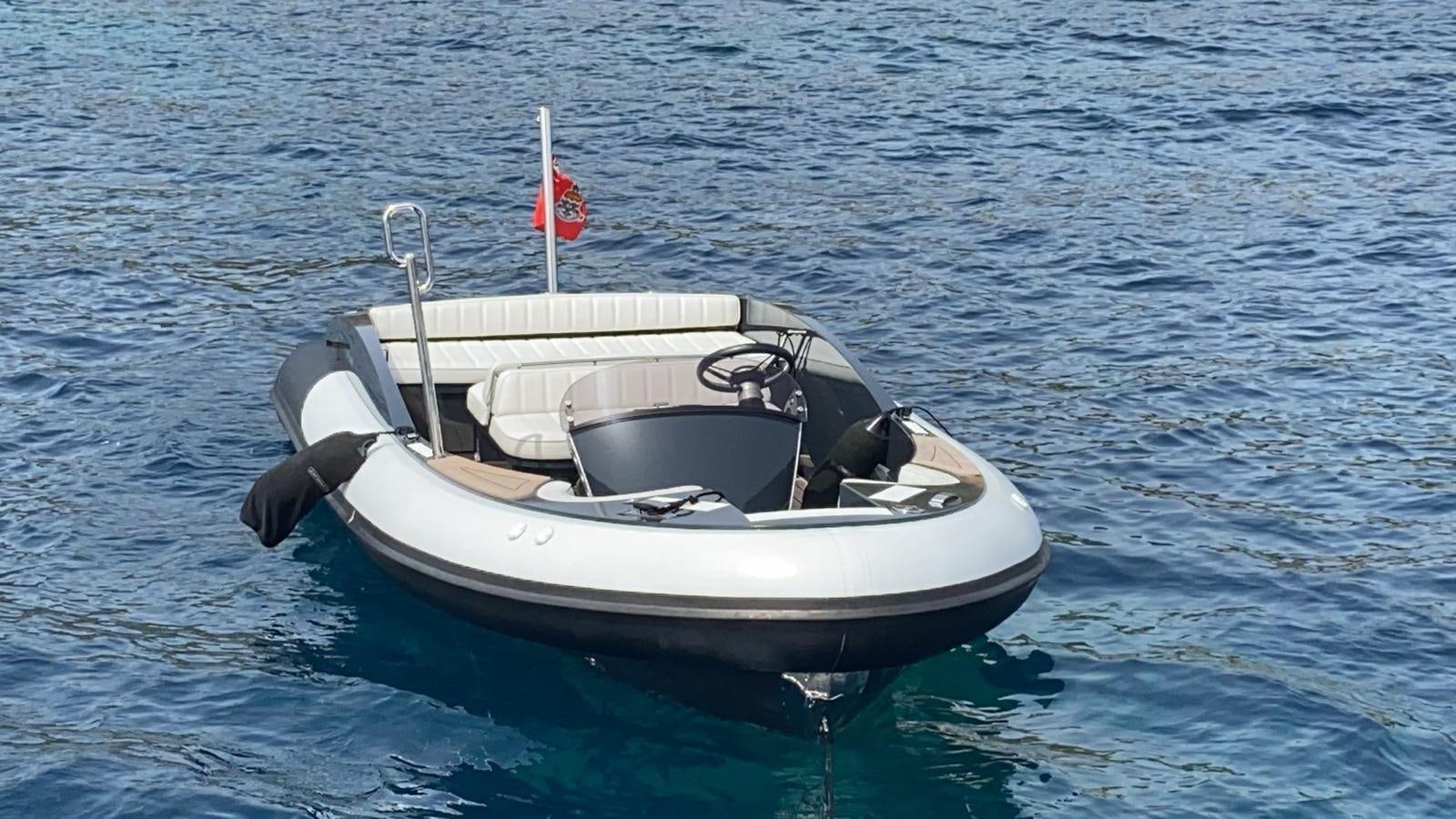 a small boat in the water aboard CLASSIC 121 Yacht for Sale