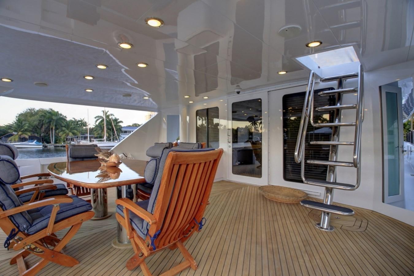 a room with a table chairs and a ladder aboard SUNDAY MONEY Yacht for Sale