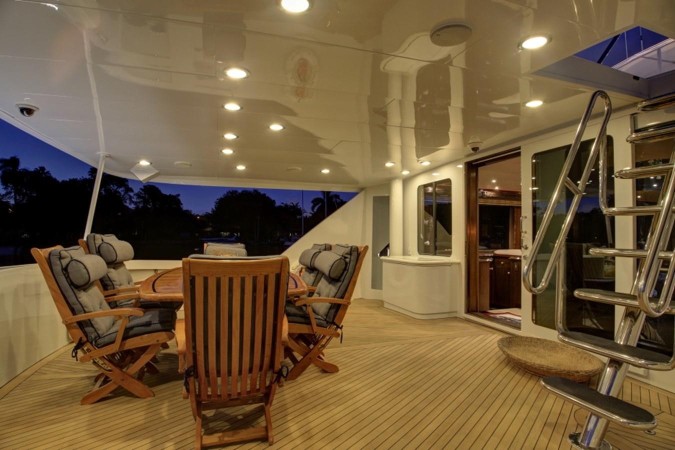 a large room with chairs and a table and a ladder aboard SUNDAY MONEY Yacht for Sale
