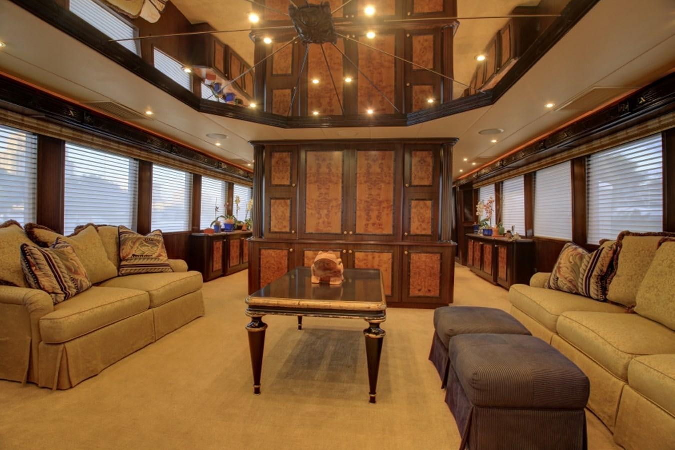 a living room with a large wood cabinet and a large window aboard SUNDAY MONEY Yacht for Sale