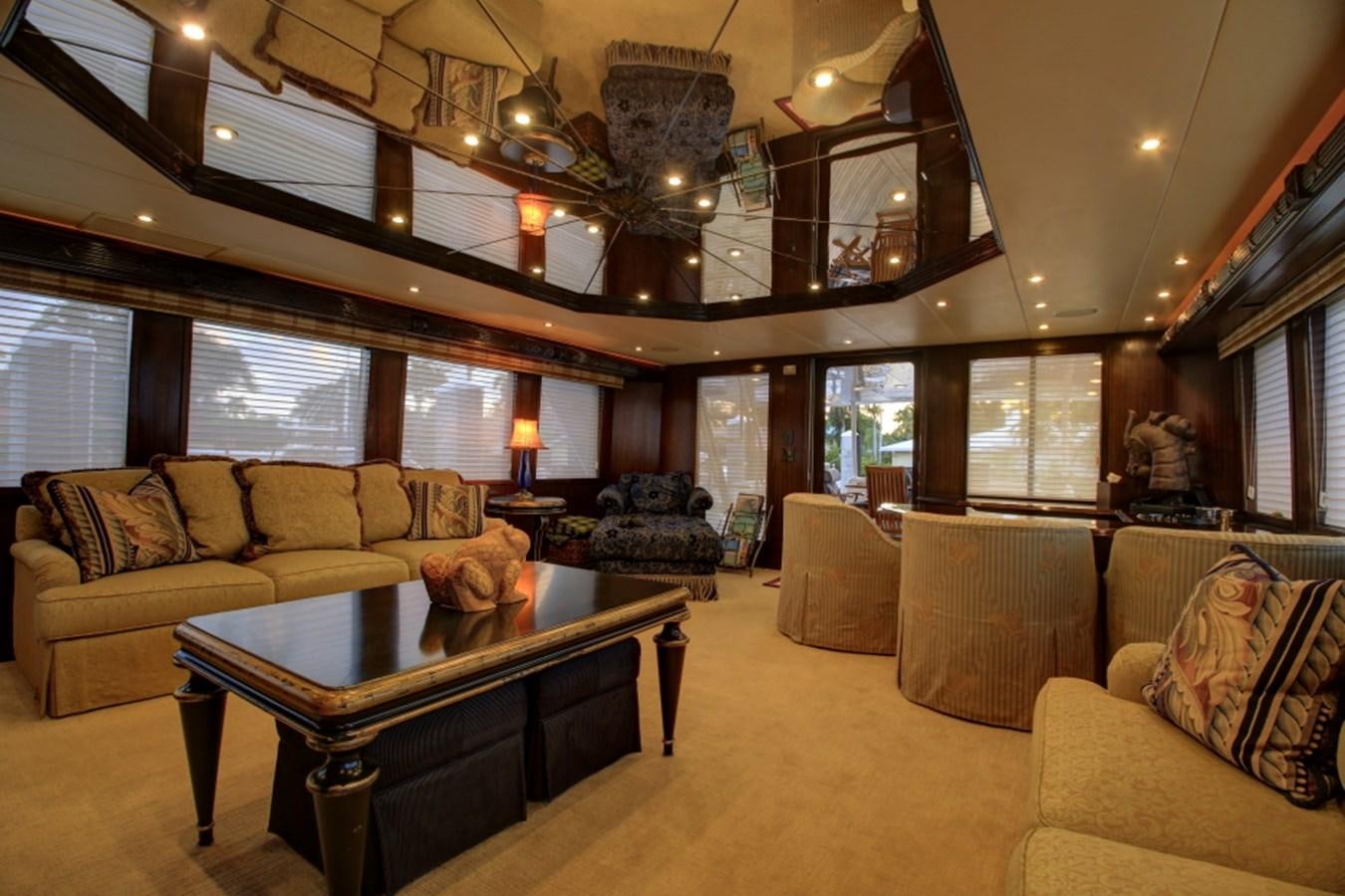 a living room with a chandelier aboard SUNDAY MONEY Yacht for Sale
